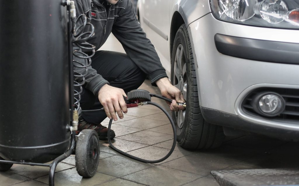 mechanic checking car tire