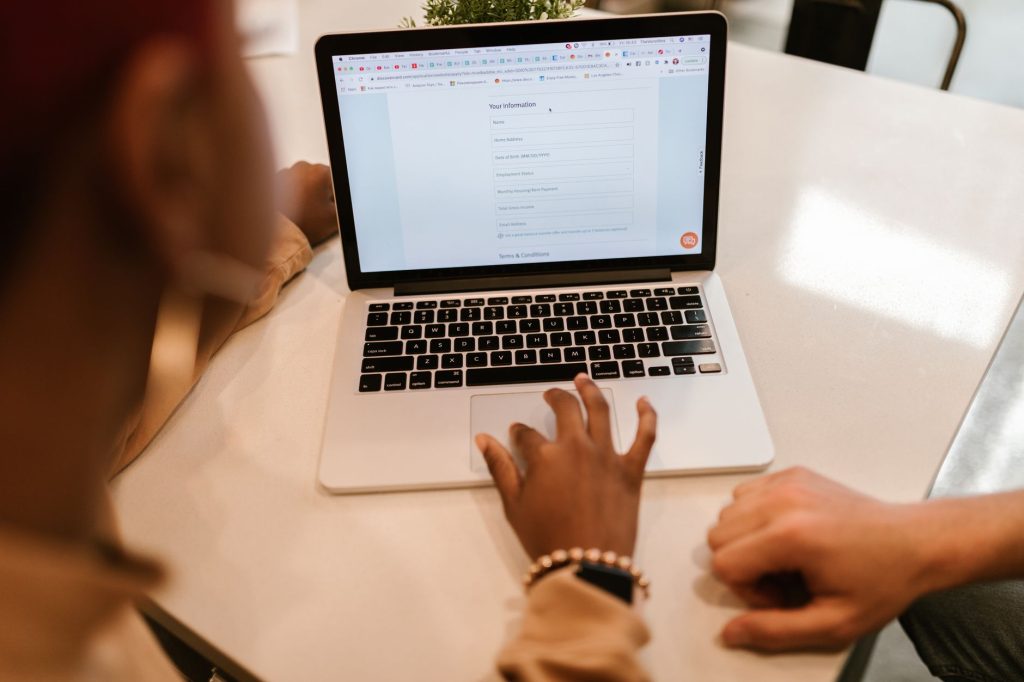 Une personne remplit un questionnaire en ligne sur un ordinateur portable